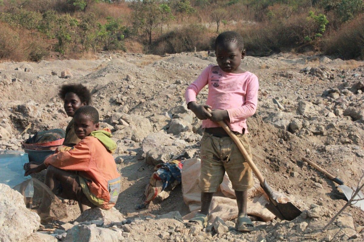 Children and adults working in an artisanal cobalt mining area in the Democratic Republic of the Congo