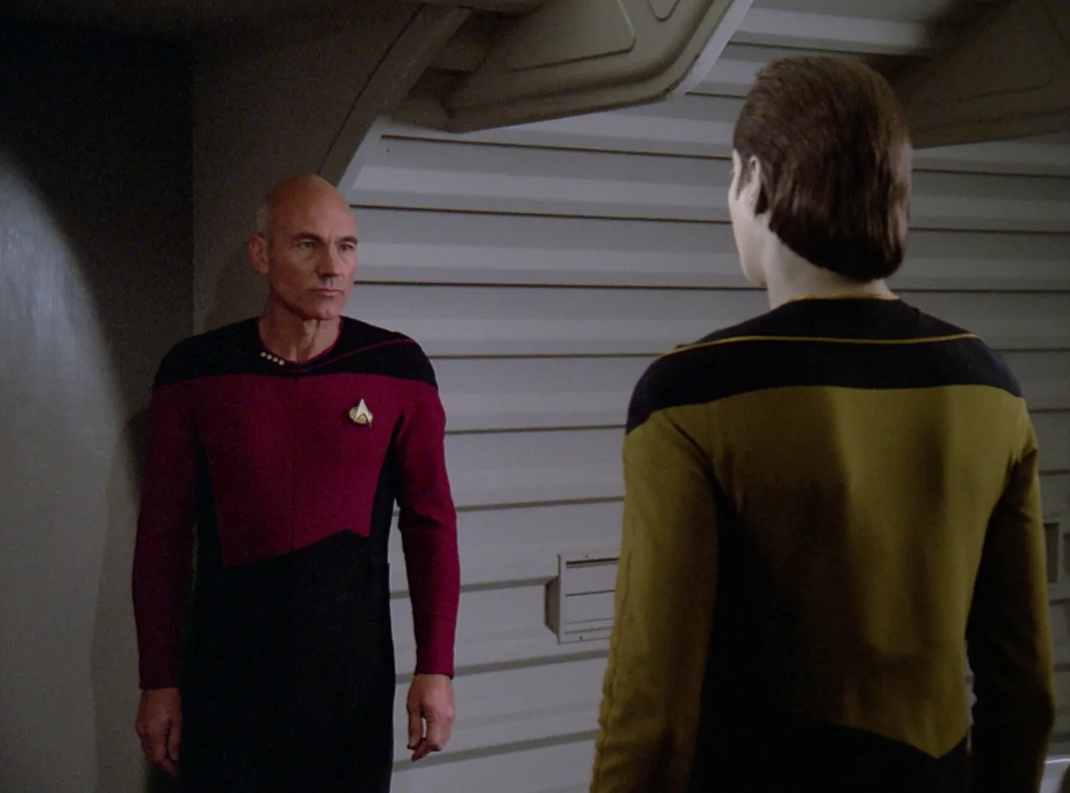 Picard standing in Data's quarters, facing Data, who has his back to the camera
