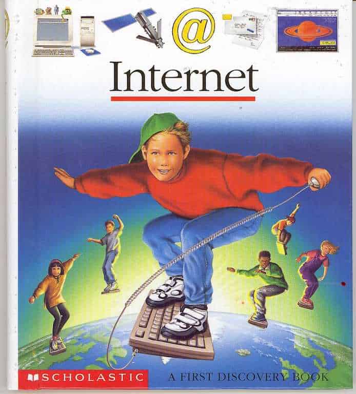 Cover of the Scholastic 'Internet' First Discovery book, showing a child riding a keyboard like a surfboard over a globe, surrounded by an @ sign, a satellite, and 90s desktop icons