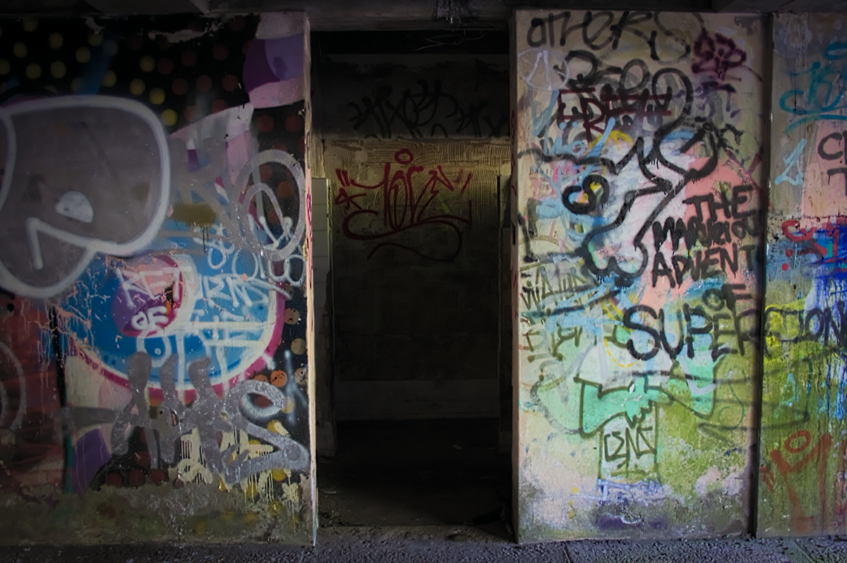 Graffiti-covered walls in an abandoned corridor