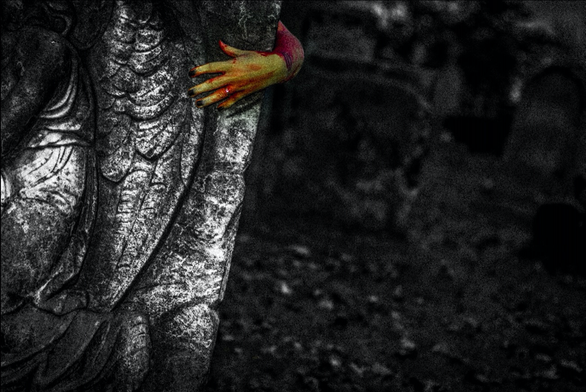 A hand on a grave.
