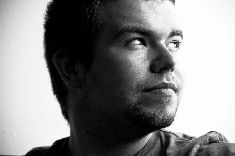 A younger Ken in black and white, looking off to the side