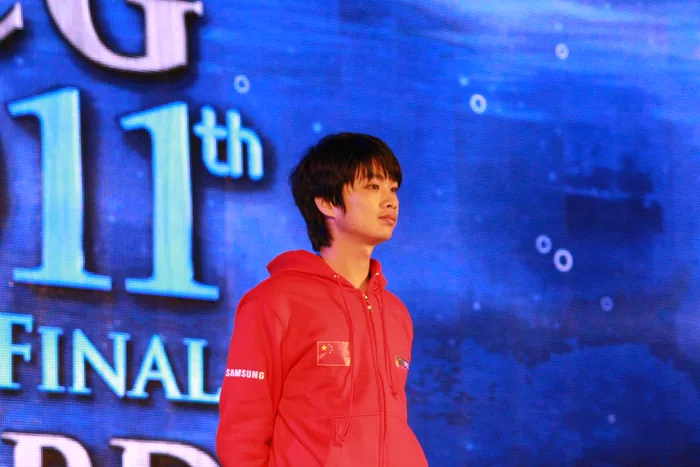 Li Sky Xiaofeng on stage in a red jacket at the World Cyber Games 2011 grand final