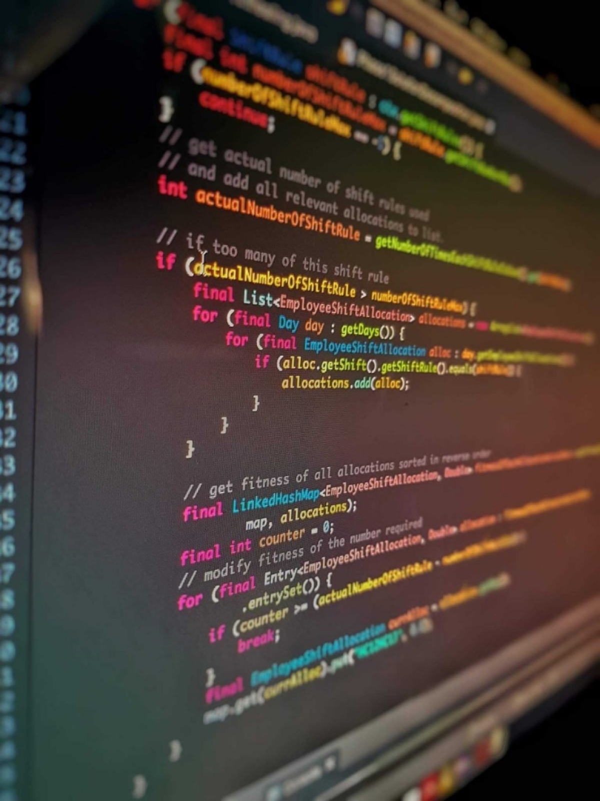 Colorful syntax-highlighted code on a dark monitor screen