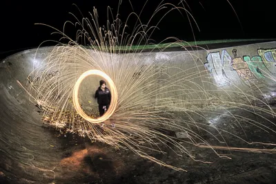 A circle of sparks from spun steel wool around a figure at night, Stirling