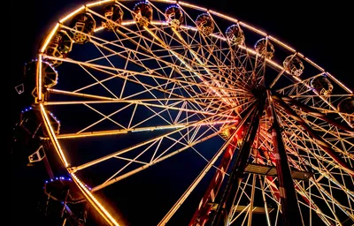 Ferris wheel lit up at night in Edinburgh, Scotland