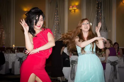 Two women dancing at a celebration